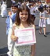 Giselle holds her diploma