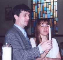 Robb and Meribel hold their candle at April 19 pre-wedding mass